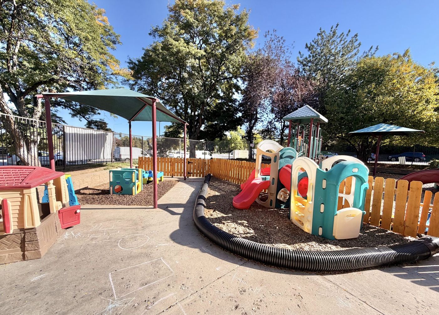 The playground with slides, a climber and a shade sail