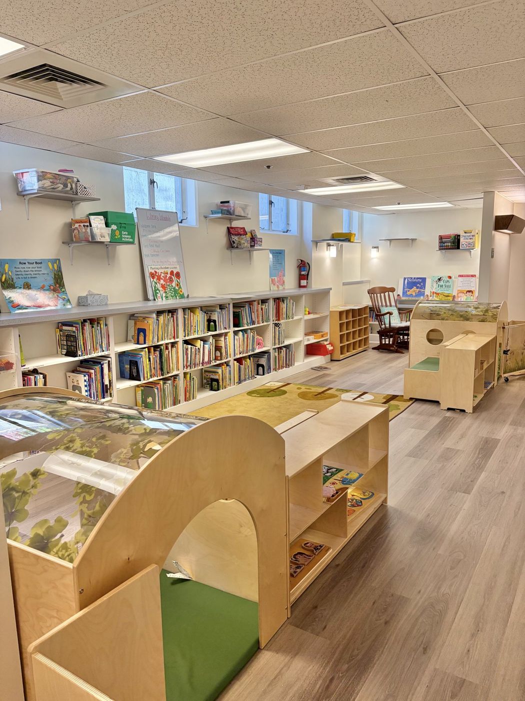 A bright classroom with bookshelves and reading nooks