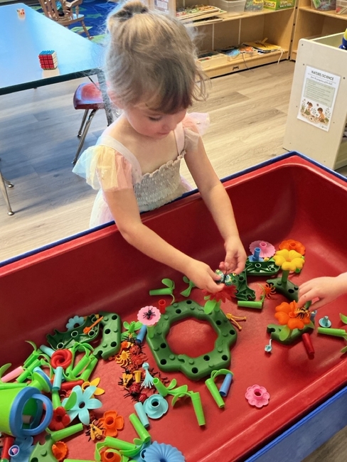A preschooler exploring a hands-on classroom activity